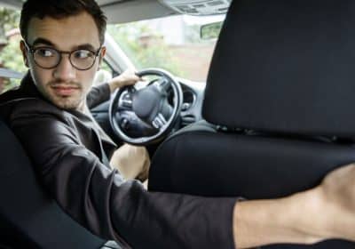 Passenger photographing damage after Uber Lyft rideshare accident in Atlanta