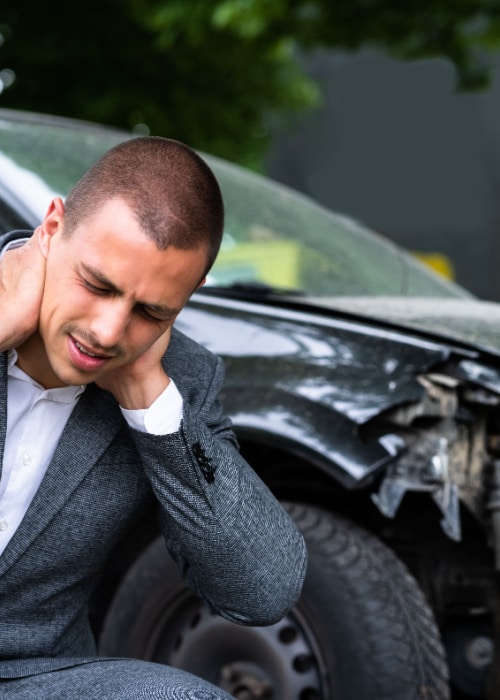 Injured driver holding neck after rear-end accident in Atlanta