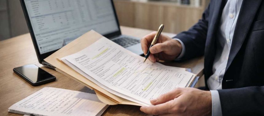 Georgia workers’ compensation settlement paperwork with pen