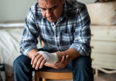 Man looking at bandaged hand after dog bite injury in Georgia