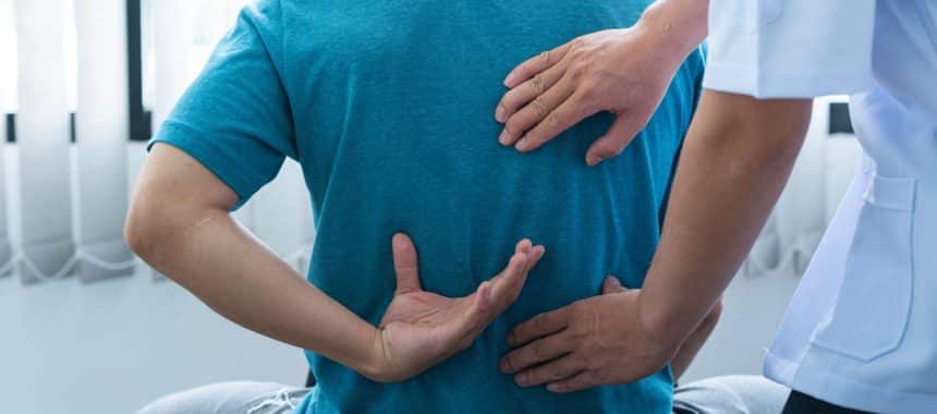 Doctor evaluating serious back and neck injury patient in Georgia