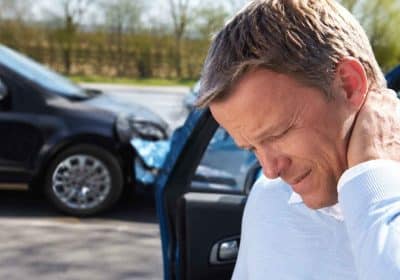 Driver holding neck after rear-end accident in Georgia